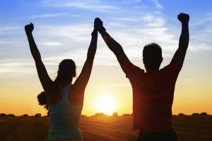 couple with arms up in success sunset augusta disability lawyer