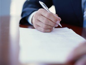 Businessman writing at desk, close-up South Carolina ERISA Attorney