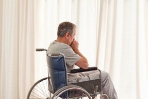 man in wheelchair at window Augusta Social Security Disability Attorney